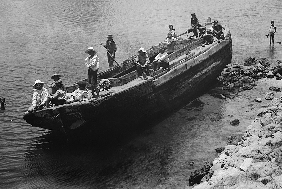 Kids playing on abandoned Barge photo.WAM.
